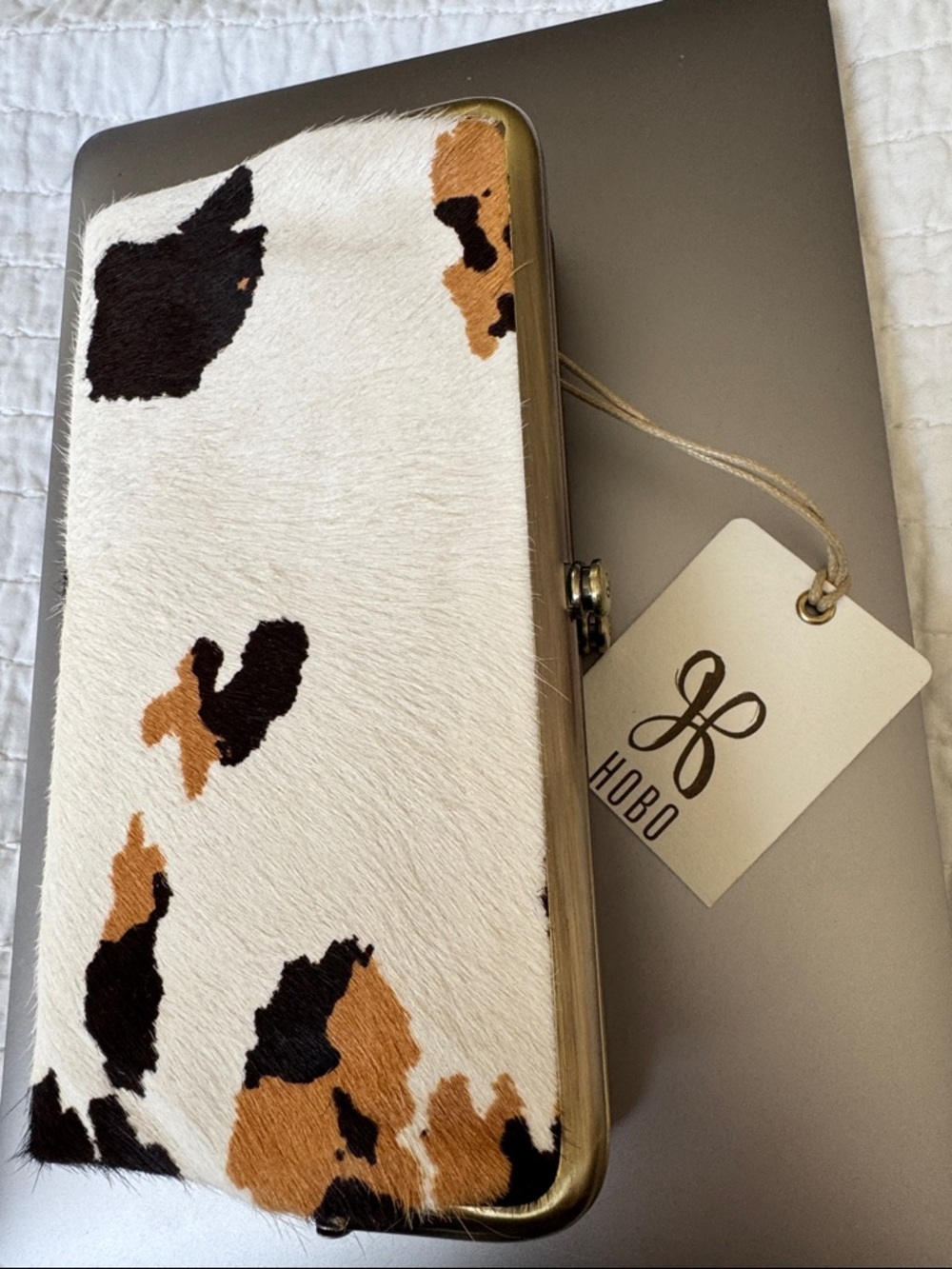 HOBO Cowhide Clutch in White, Black & Brown Spotted Pattern